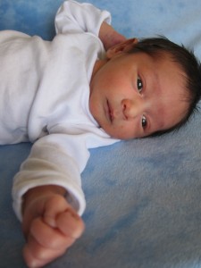 Liam on his side with fist toward camera